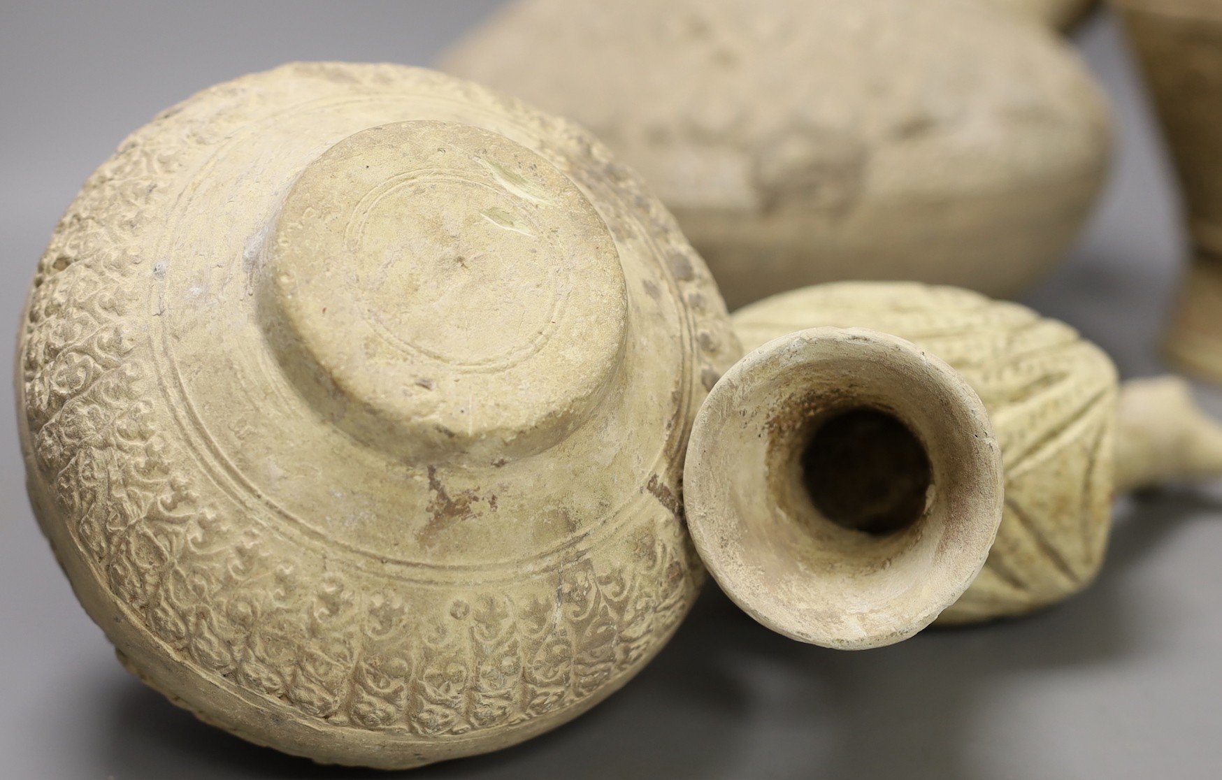 A selection of four Islamic terracotta vessels, Middle Eastern possibly 12th century, the animal headed ewer 22 cm high